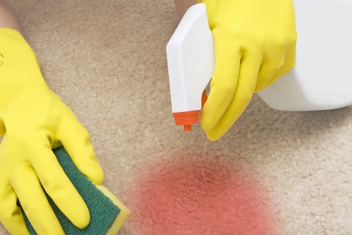 Carpet cleaning team using protective measures in a home setting